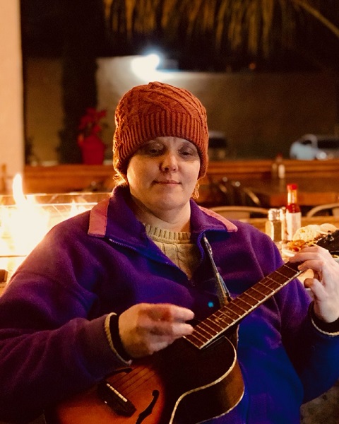 Singing outside in front of the fire. Photo by Calixto Flores of Max Pictures.