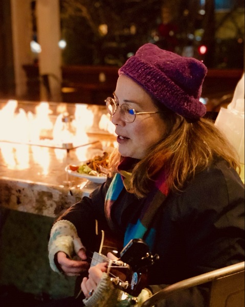 Singing outside in a cat hat. Photo by Calixto Flores of Max Pictures.