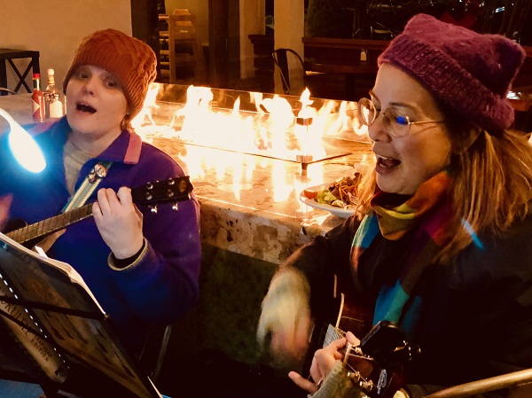 Two of us singing outside in cat hats. Photo by Calixto Flores of Max Pictures.